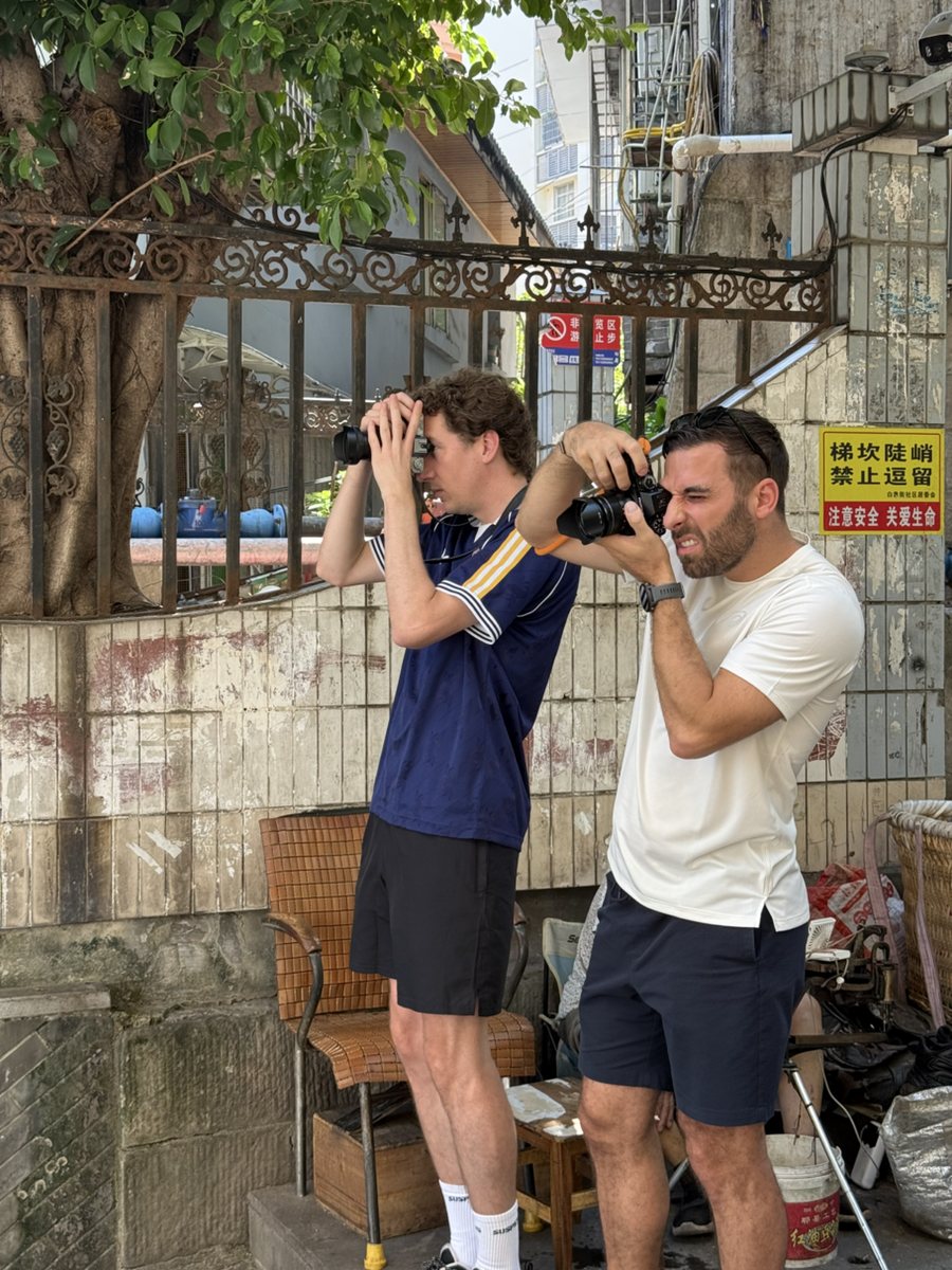 Guests exploring the layered residential walkways of Baixiangju