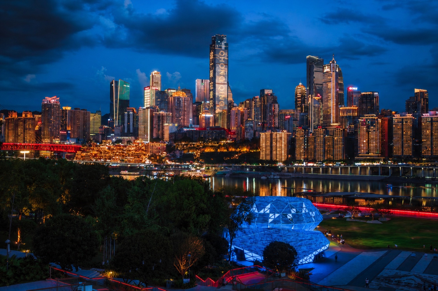 Chongqing's illuminated riverside skyline at blue hour