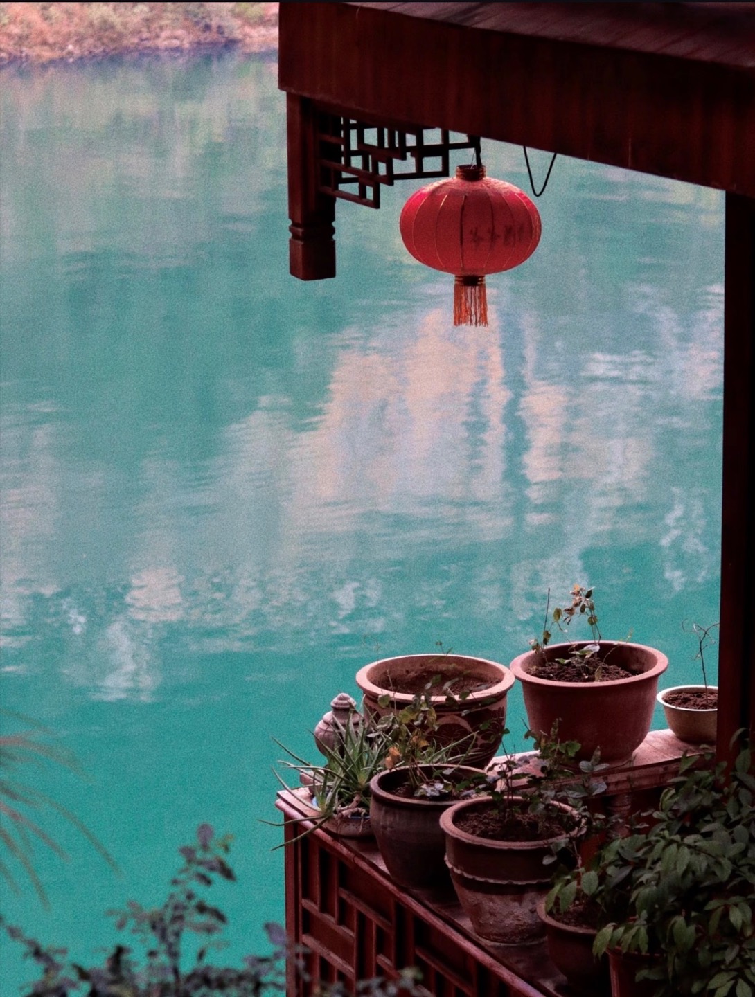 Lanterns and riverside details along Gongtan's traditional buildings